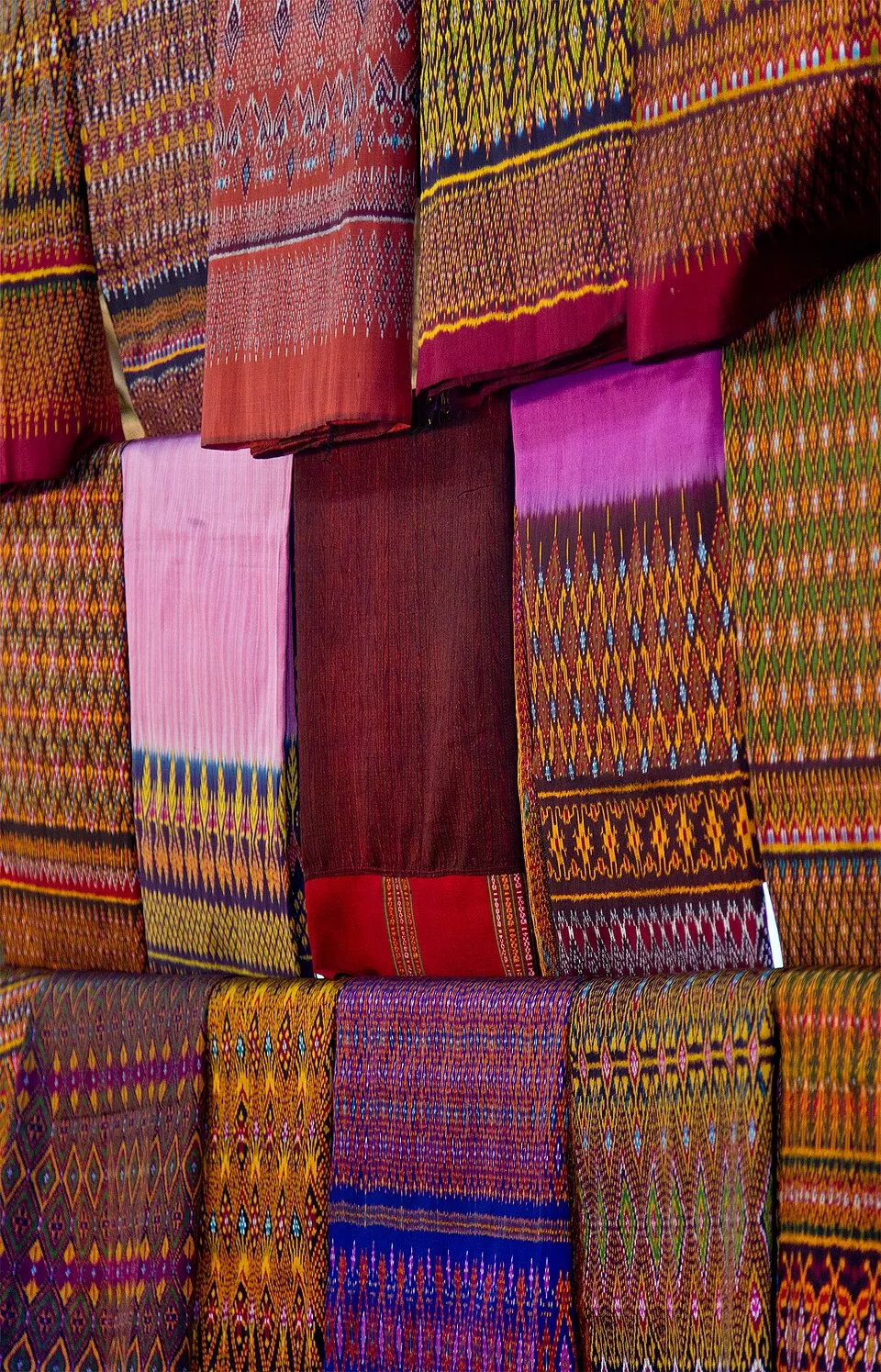 Colorful patterned silk fabrics hanging in Ban Tha Sawang, Surin.